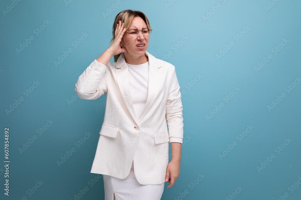 blond surprised young business lady in an elegant jacket looks attentively to the side blond surprised young business lady in an elegant jacket looks attentively to the side
