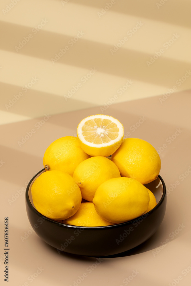 Still life yellow ripe lemons in a ceramic plate with a sprig of mint on the table. Copy space Still life yellow ripe lemons in a ceramic plate with a sprig of mint on the table. Copy space