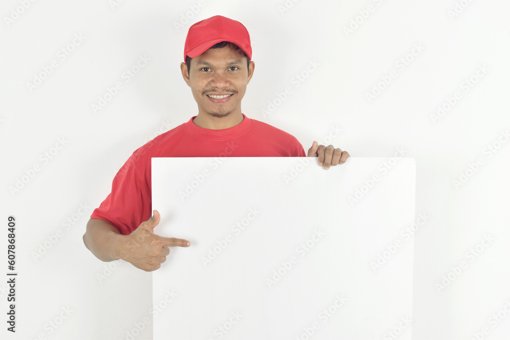 Delivery man pointing finger towards big white blank billboard with copy space, place for text image. Delivery man pointing finger towards big white blank billboard with copy space, place for text image.
