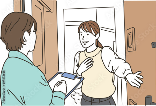 訪問作業員の女性と玄関で応対をする女性
