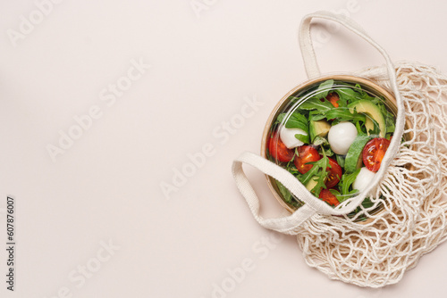 Cardboard bowl container with fresh caprese salad. Food delivery, zero waste, recycling packaging, eco friendly concept