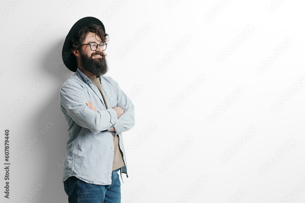 Handsome stylish man with beard on white background. Smiling man wearing black hat and glasses Handsome stylish man with beard on white background. Smiling man wearing black hat and glasses
