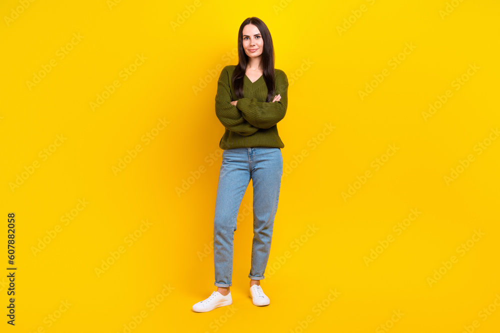 Full length portrait of charming positive person folded hands posing isolated on yellow color background Full length portrait of charming positive person folded hands posing isolated on yellow color background