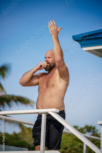 Florida lifeguard waving people to come closer to the shore