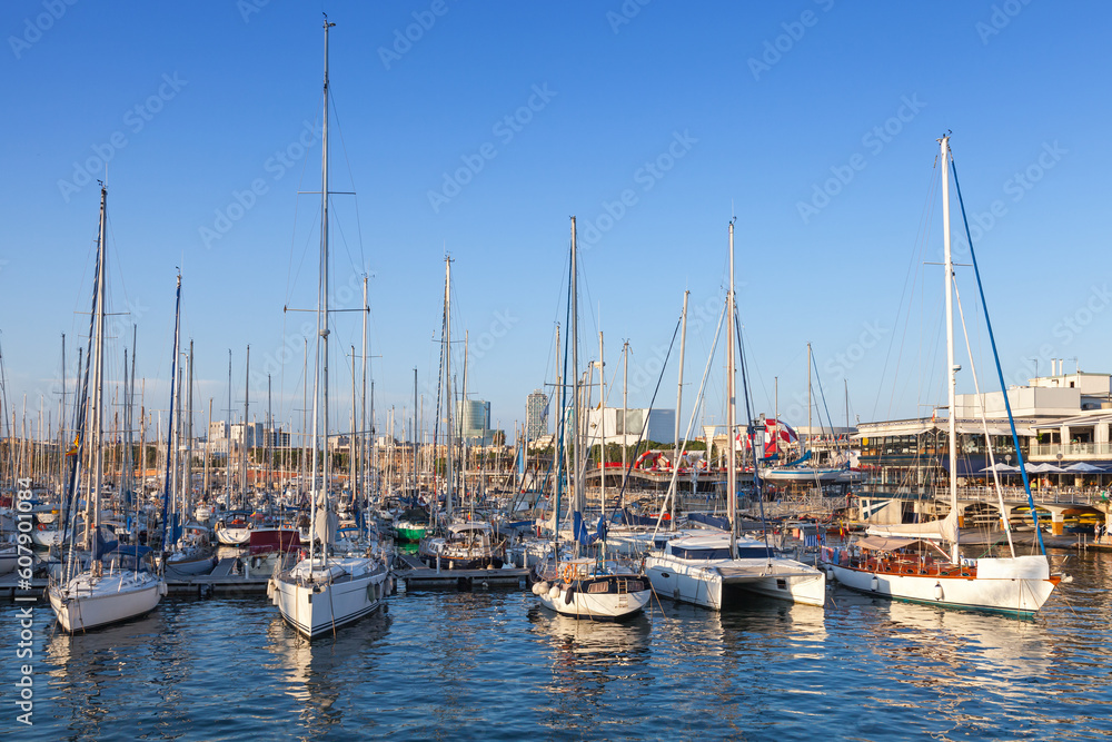 Sailing yachts and pleasure boats are moored in Barcelona port