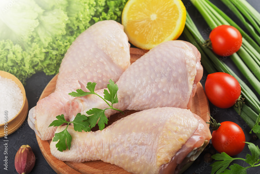 raw chicken legs and marinade ingredients on a kitchen board raw chicken legs and marinade ingredients on a kitchen board
