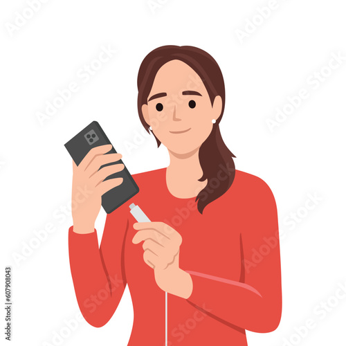 Woman holding smartphone uses cable to charge battery after seeing red indicator of dead accumulator. Girl with mobile phone connects type-c or usb mini wire for fast battery charging