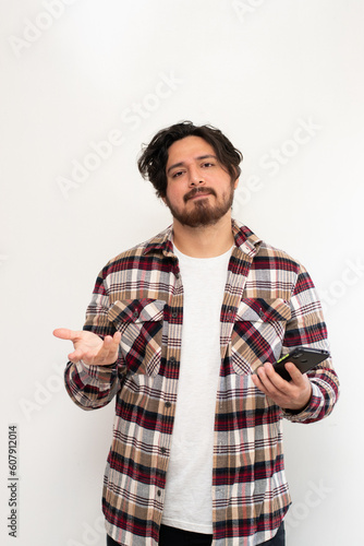 Portrait of young man making disappointment while hold a cell phone in white backaground