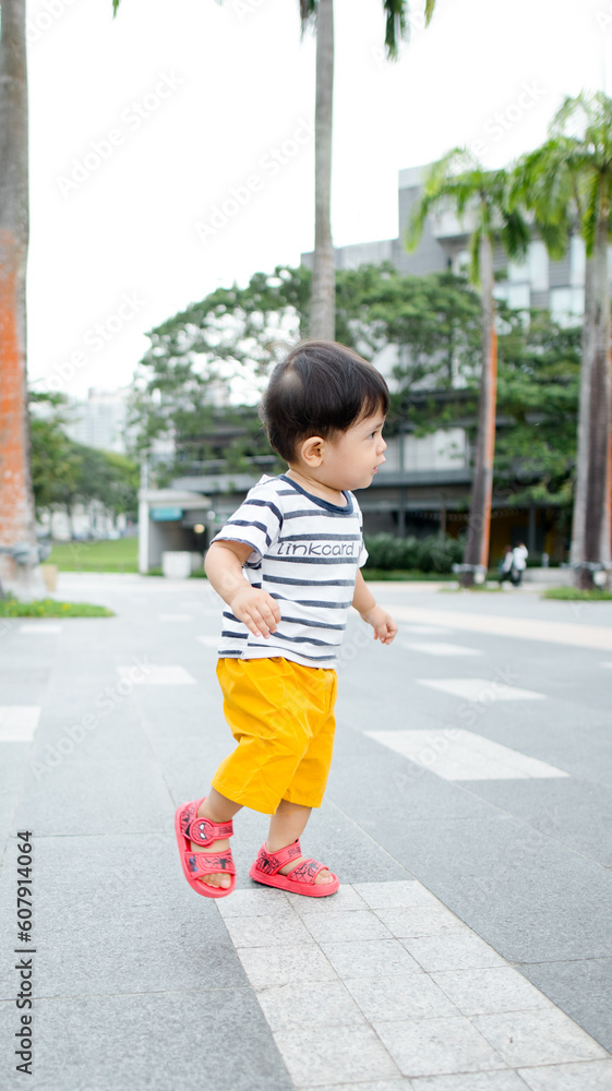 A Malay boy wearing stripes clothes and yellow pants at the bay