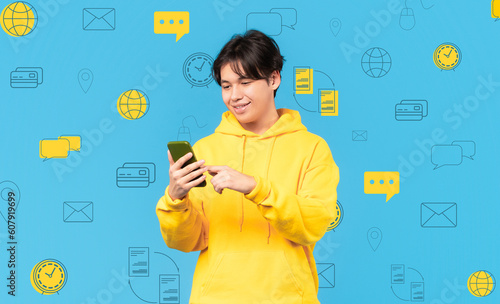 Smiling asian man with phone over diverse digital world icons