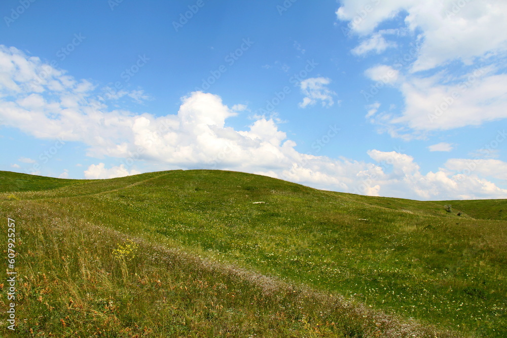 Green hill under the sky with clouds Green hill under the sky with clouds