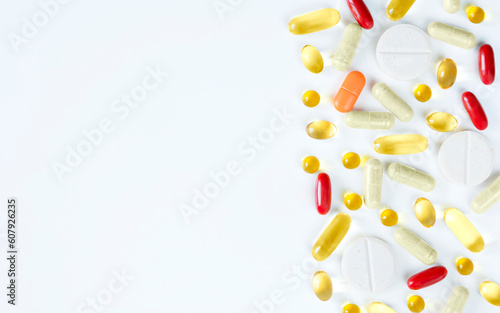 Set of colourful pills,capsules and tablets of vitamins on white background flat lay with copy space. Healthy balance lifestyle concept.