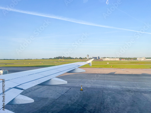 In Flight - Flying and traveling, view from airplane window of the wing with Frankfurt airport view. Travel, Flight, airline, holiday, tourism concept