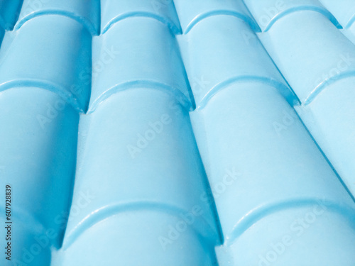 Pattern of rounded colonial roof made of blue plastic.