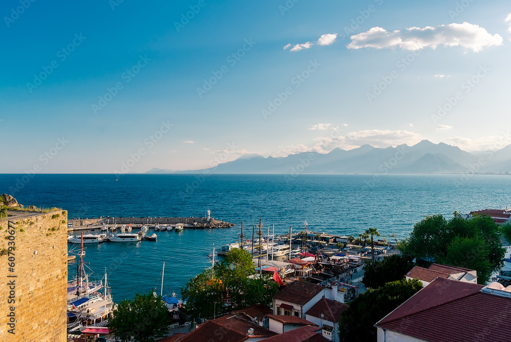Obraz premium Panorama view from a high point on part of the fortress wall and the old port of Kaleichi in the Turkish city of Antalya. Panoramic view of part of the fortress wall and the old port 