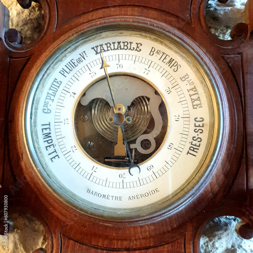 Фотография Vintage wooden barometer and thermometer