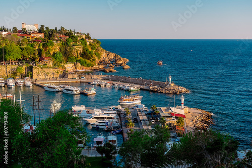 View from a height of the harbor near the old town of Kaleichi in the Turkish city of Antalya. Old port in Antalya with many ships and boats. Popular tourist place in Anatalya. photo