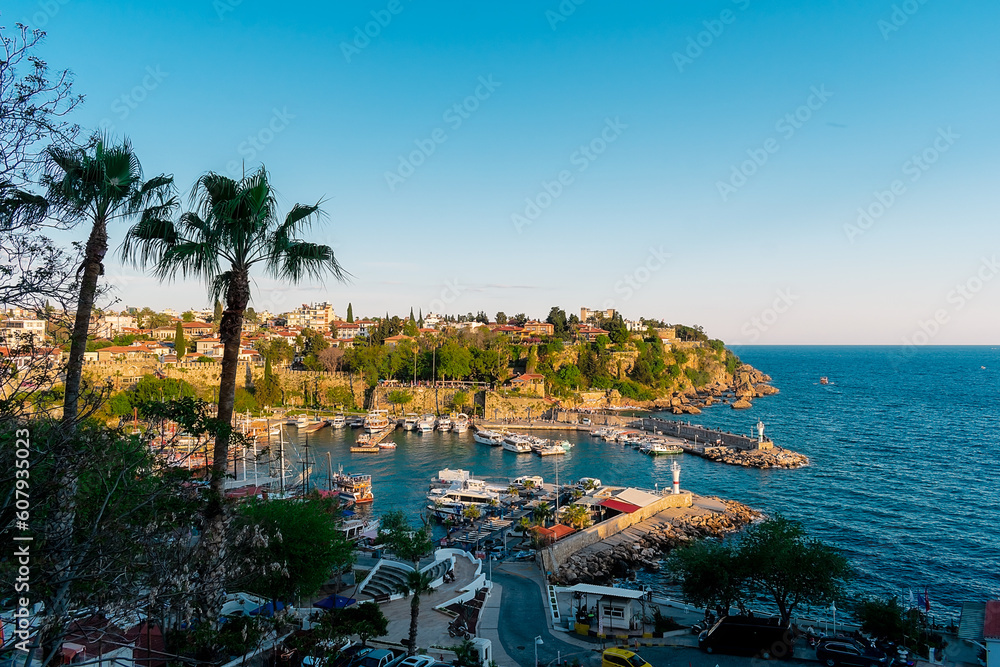 Fototapeta premium View from a height of the harbor near the old town of Kaleichi in the Turkish city of Antalya. Old port in Antalya with many ships and boats. Popular tourist place in Anatalya.