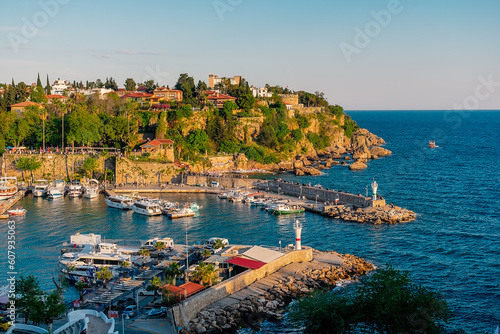 View from a height of the harbor near the old town of Kaleichi in the Turkish city of Antalya. Old port in Antalya with many ships and boats. Popular tourist place in Anatalya. photo