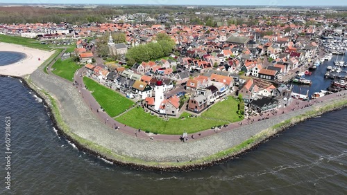 Boulevard and coastline of Urk in the netherlands. also the lighthouse of urk can be seen photo