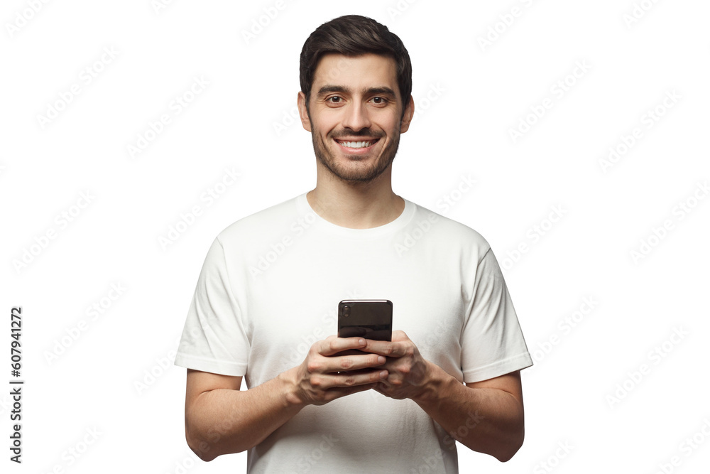 Handsome smiling man looking at camera while holding his smart phone, isolated on gray background Handsome smiling man looking at camera while holding his smart phone, isolated on gray background