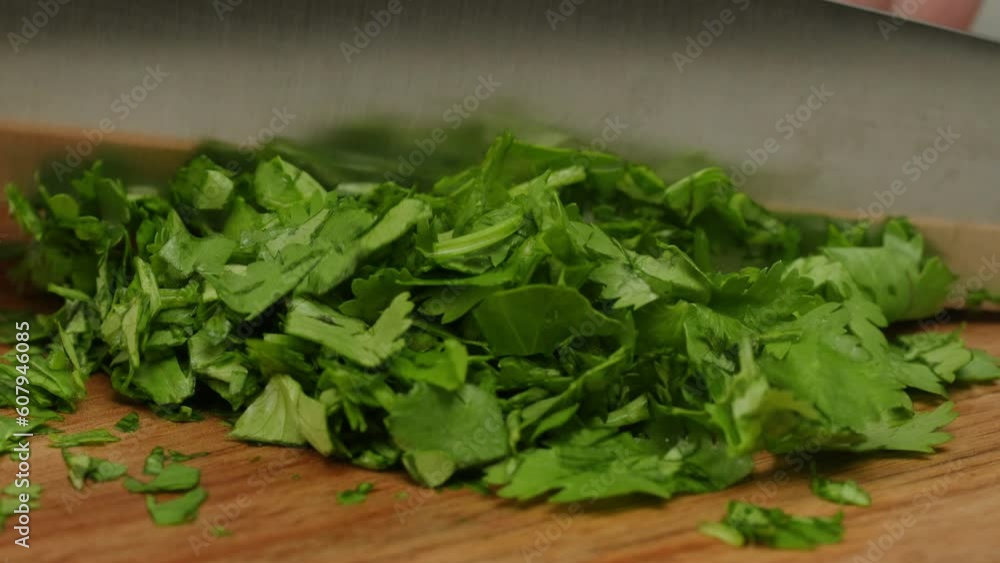 Cilantro parsley cutting by knife close up, chef chop cut coriander aromatic, traditional asian and Mexican cuisine herb studio shot. Cilantro parsley cutting by knife close up, chef chop cut coriander aromatic, traditional asian and Mexican cuisine herb studio shot.