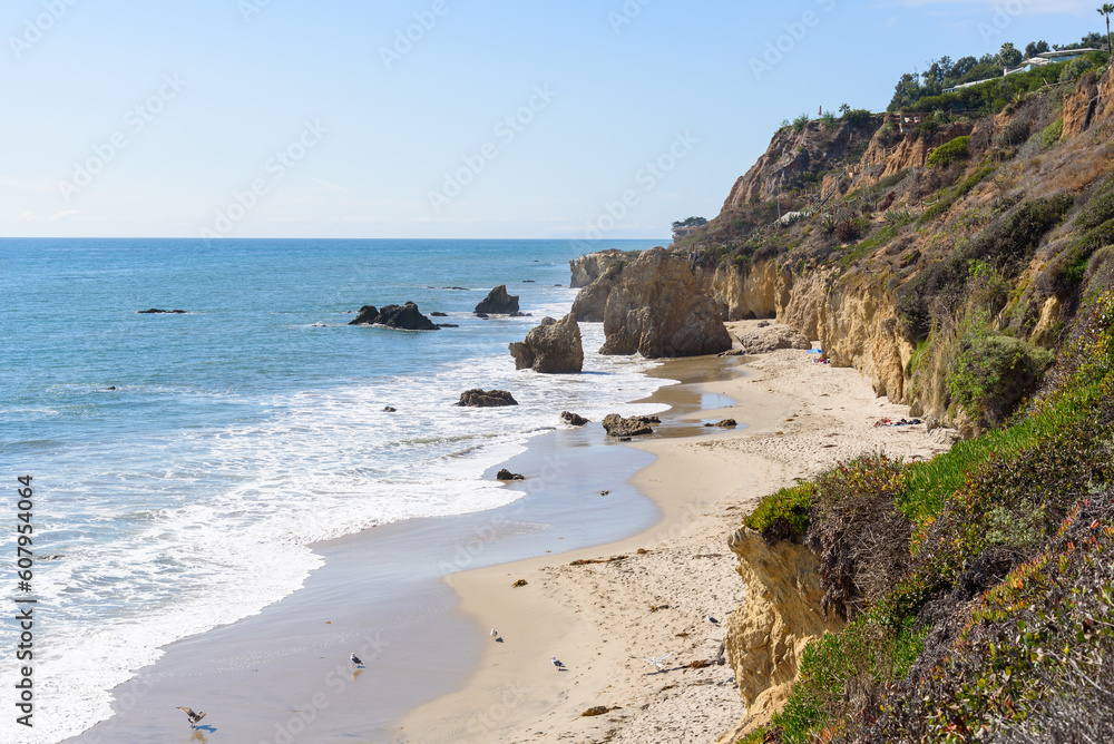 View form above of a beautiful sandy beach along the coast of California on a sunny autumn day