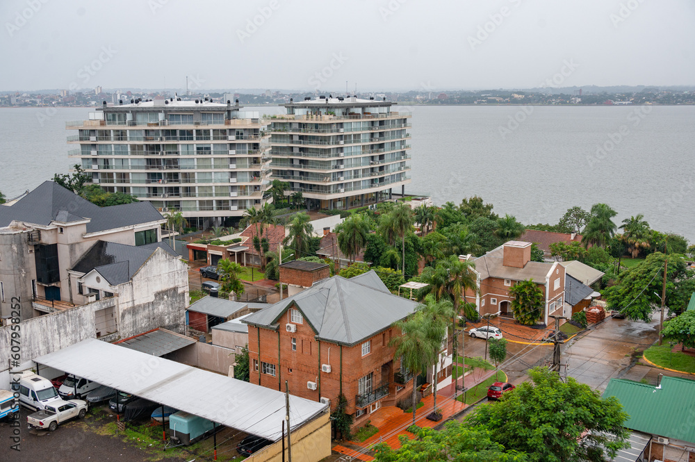 Fototapeta premium Buildings, houses and vegetation in Posadas, Argentina. Nearby town of Encarnacion in Paraguay. Cityscape photography.
