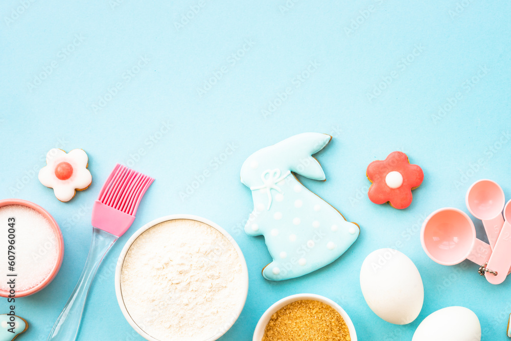 Easter baking, Flour, edds, sugar and gingerbread cookies. Top view on blue. Easter baking, Flour, edds, sugar and gingerbread cookies. Top view on blue.