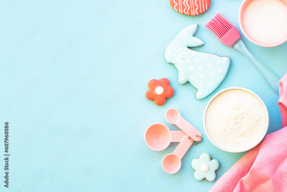 Easter baking, Flour, edds, sugar and gingerbread cookies. Top view on blue. Easter baking, Flour, edds, sugar and gingerbread cookies. Top view on blue.