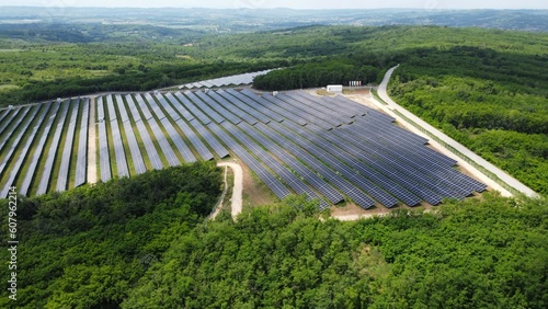 Aerial view of the rows of solar panels, large solar power plant. Production of a large amount of clean electricity from renewable sources. The concept of zero emissions and environmental protection