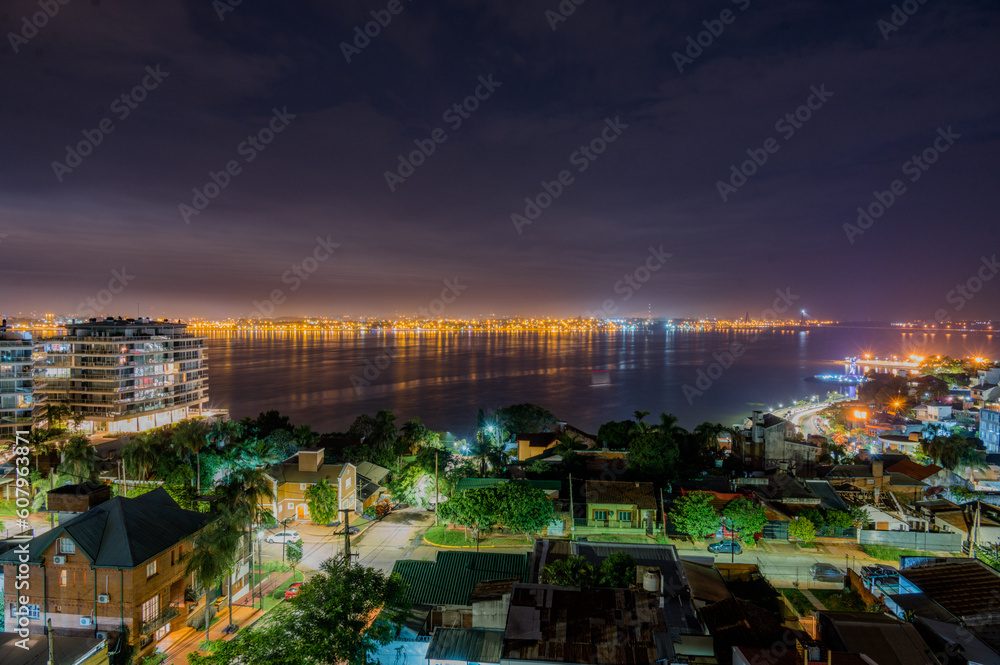 Obraz premium Dramatic night with many clouds in the city of Posadas, Argentina. Long exposure night photography.
