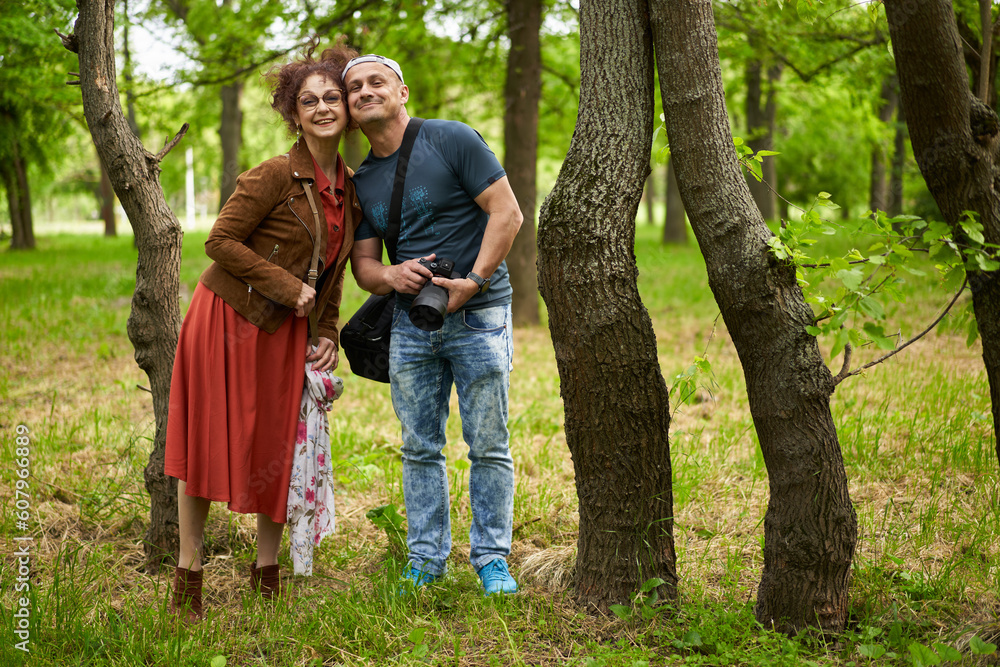 Photographer with his mature model in the park Photographer with his mature model in the park