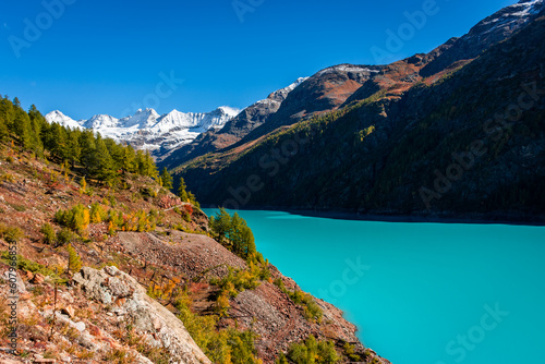 Fototapeta Naklejka Na Ścianę i Meble -  Autumnal landscape of the Lake Place Moulin, an artificial glacial lake with turquoise water in the italian Alps,  on the border with Switzerland