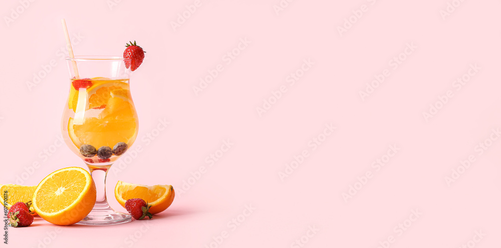 Glass of orange infused water on pink background with space for text Glass of orange infused water on pink background with space for text