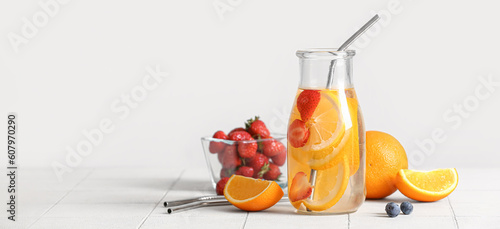 Composition with orange infused water on light background