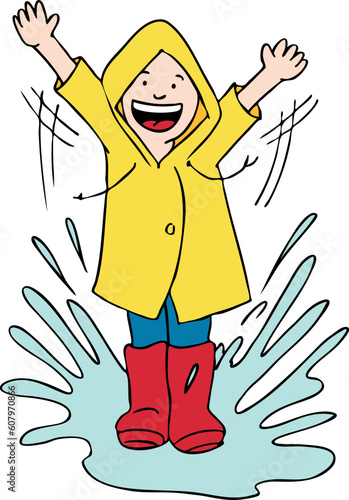 Boy splashes in a puddle from the rain.