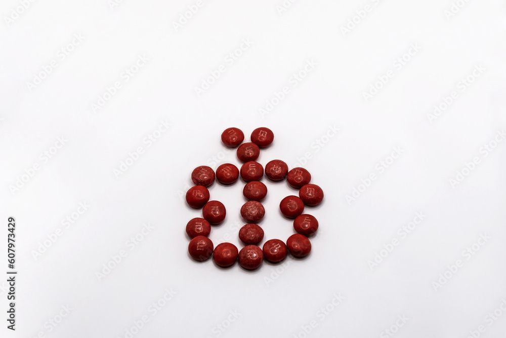 Red butterfly made of chocolate candies isolated on white background. Red butterfly made of chocolate candies isolated on white background.