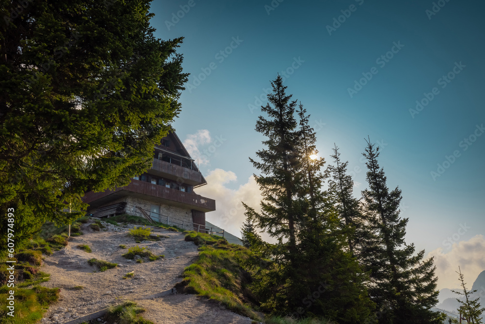Beautiful alpine hut on Golica mountain visible from below.Nice forest in the background. Slovenian alpine cottages surrounded by green scenery