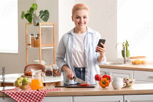 Smiling woman chopping vege...