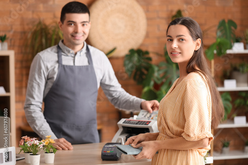 Male cashier using cash cou...