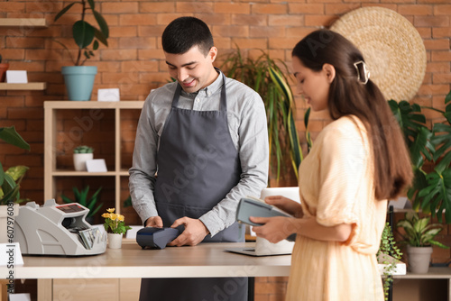 male cashier using payment ...