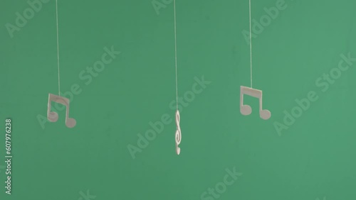 three musical notes on green background, chroma key
