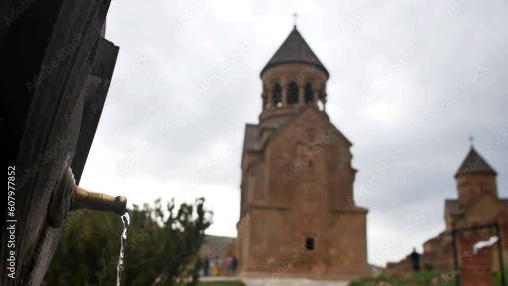 A trickle of clean drinking water flows from a pipe near a stone Christian church. Armenian pulpulak on the territory of the church. Culture and religion A trickle of clean drinking water flows from a pipe near a stone Christian church. Armenian pulpulak on the territory of the church. Culture and religion