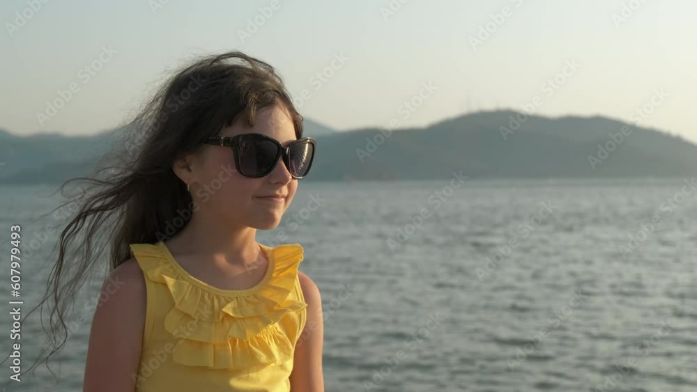 Child in sunglasses. Adorable little girl in sunglasses enjoys the sea breeze. Child in sunglasses. Adorable little girl in sunglasses enjoys the sea breeze.
