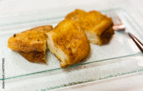 Traditional Spanish spring sweet toasts Madrilenian torrijas on glass plate