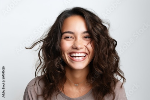 Close up portrait of a happy young woman laughing isolated over white background