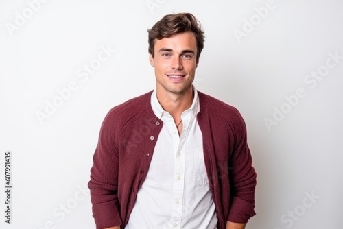 Portrait of young handsome Hispanic man smiling and looking at camera.