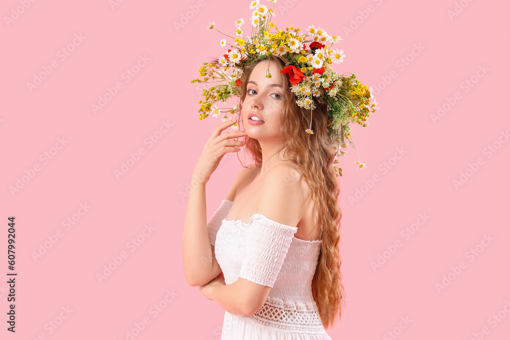 Beautiful young woman in flower wreath on pink background. Summer solstice Beautiful young woman in flower wreath on pink background. Summer solstice
