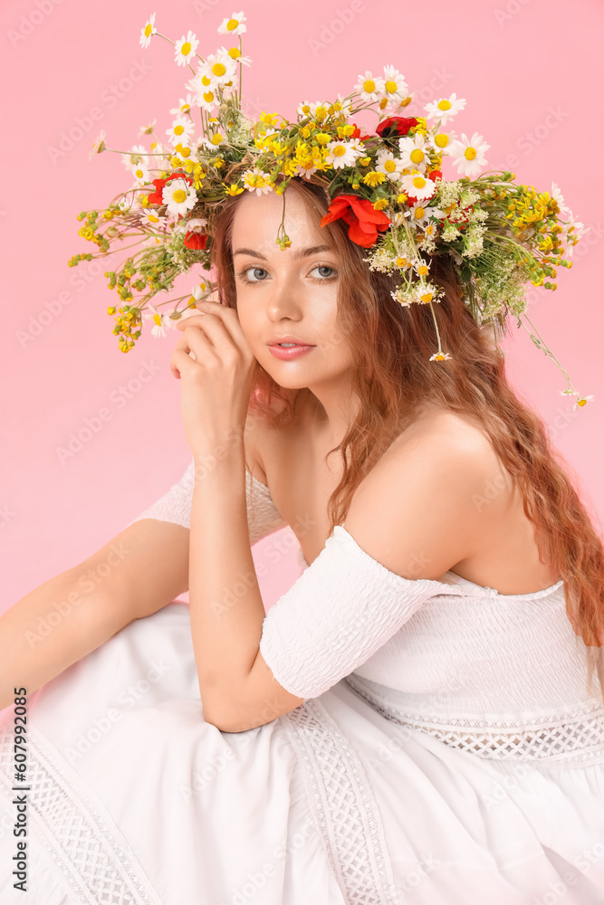 Beautiful young woman in flower wreath on pink background. Summer solstice Beautiful young woman in flower wreath on pink background. Summer solstice